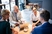 Restaurant owners meeting with business managers to discuss payroll solutions