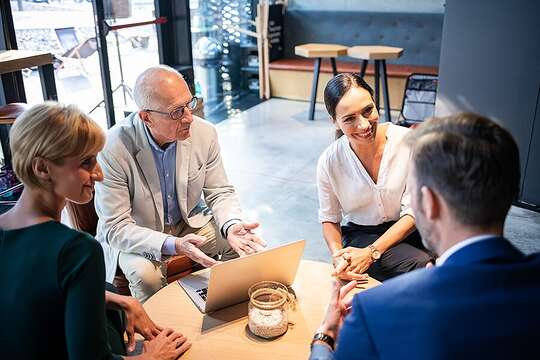 Restaurant owners meeting with business managers to discuss payroll solutions